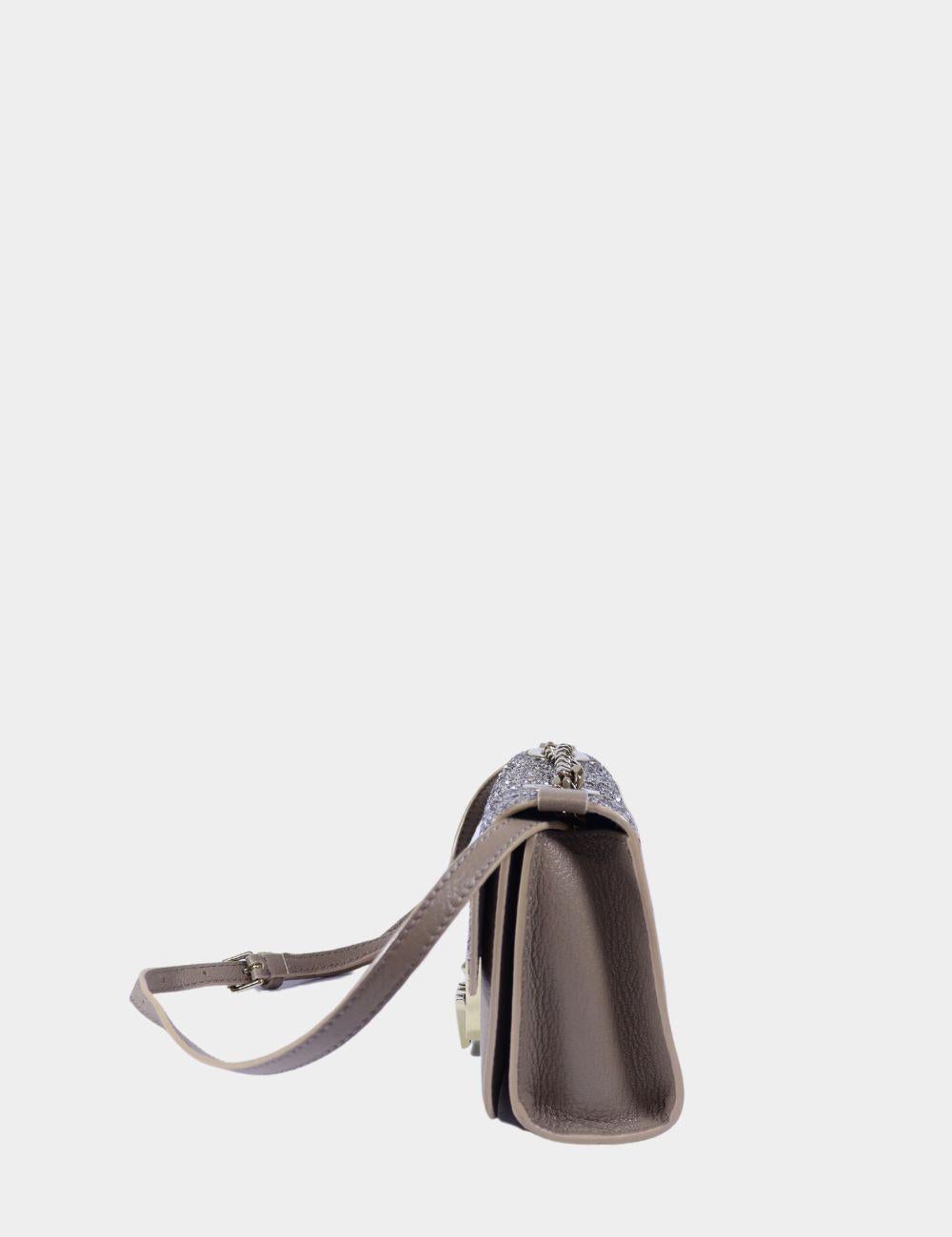 Jimmy Choo Glitter and Leather Mini Rebel Crossbody Bag, features an adjustable  shoulder strap, logo at front, and a front lock.

Material: Leather
Hardware: gold
Height: 14cm
Width: 18cm
Depth: 6cm
Shoulder Drop: 50cm 
Overall condition: