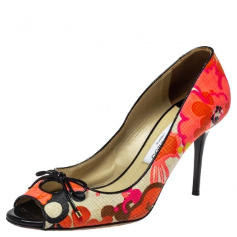 Dazzle the crowds and make a statement like never before in these gorgeous pumps from Jimmy Choo! The multicolor pumps have been crafted from floral printed canvas into a peep-toe style. They are fabulously detailed with delicate bows on the uppers