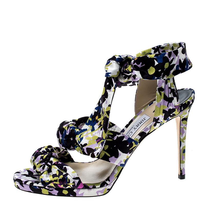 Sing the tune of the season with this gorgeous pair of sandals from Jimmy Choo. They are bursting with fresh floral prints and the satin straps in knots add a modern touch. Thin platforms, ankle ties, and slim 11 cm heels make the sandals ready to