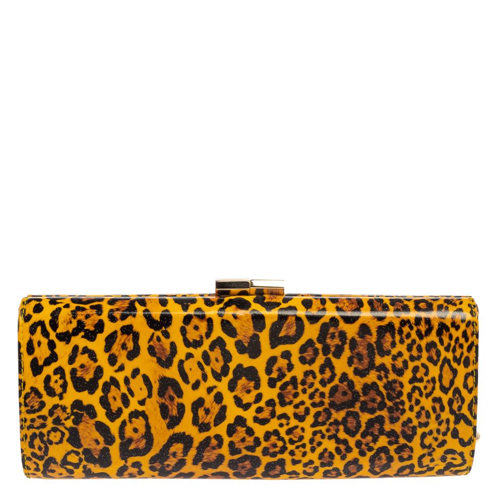 This Tube Clutch by Jimmy Choo is crafted from patent vinyl and features leopard prints on the exterior. Its construction provides an elegant allure and the gold-tone hardware frame adds a refined touch. The interior is satin-lined and will safely
