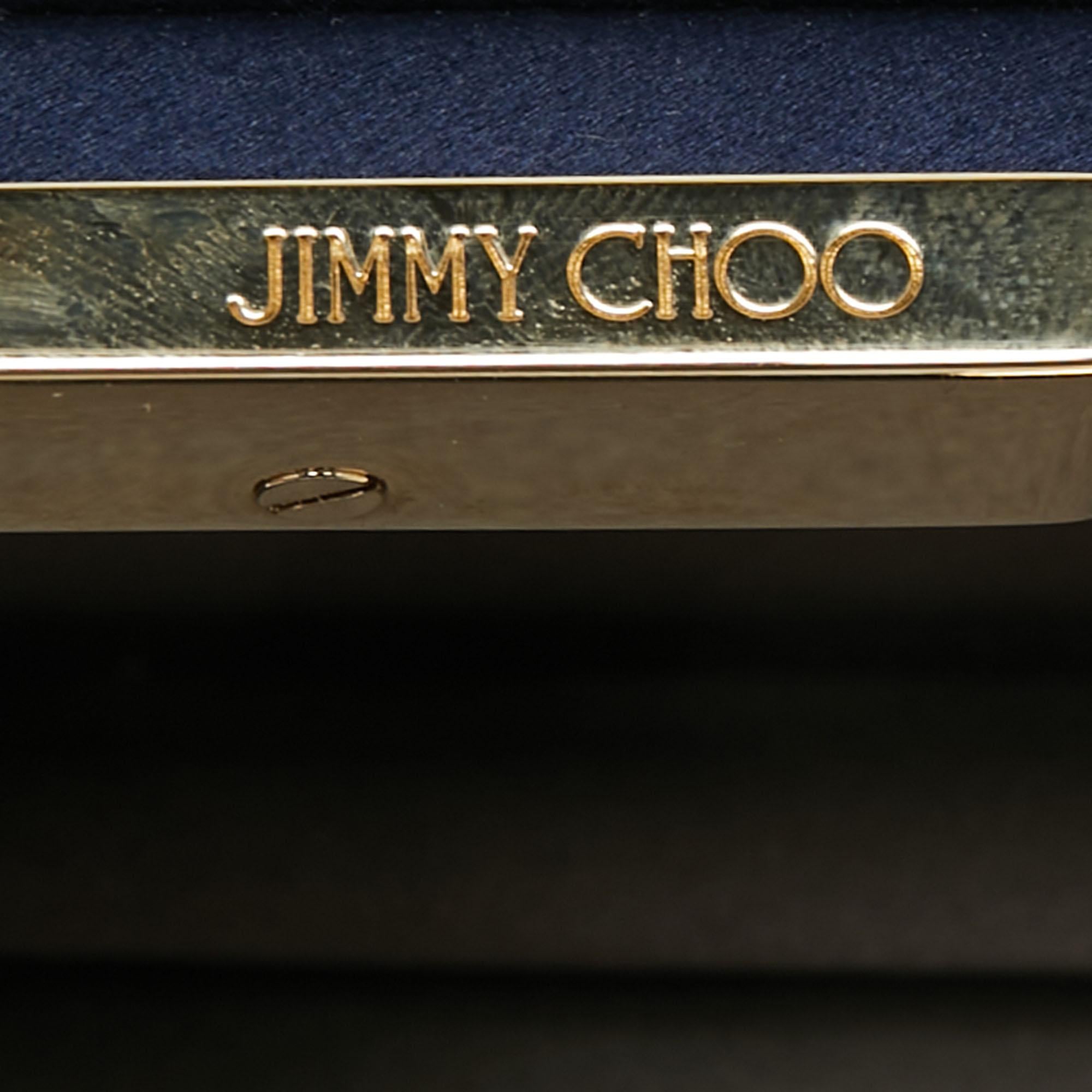 This clutch from Jimmy Choo has an appealing design, perfect to complement an evening dress or a day ensemble. Crafted from navy blue satin and gold-tone metal, the creation has a luxe appeal, a lined interior, and a shoulder chain.

Includes: