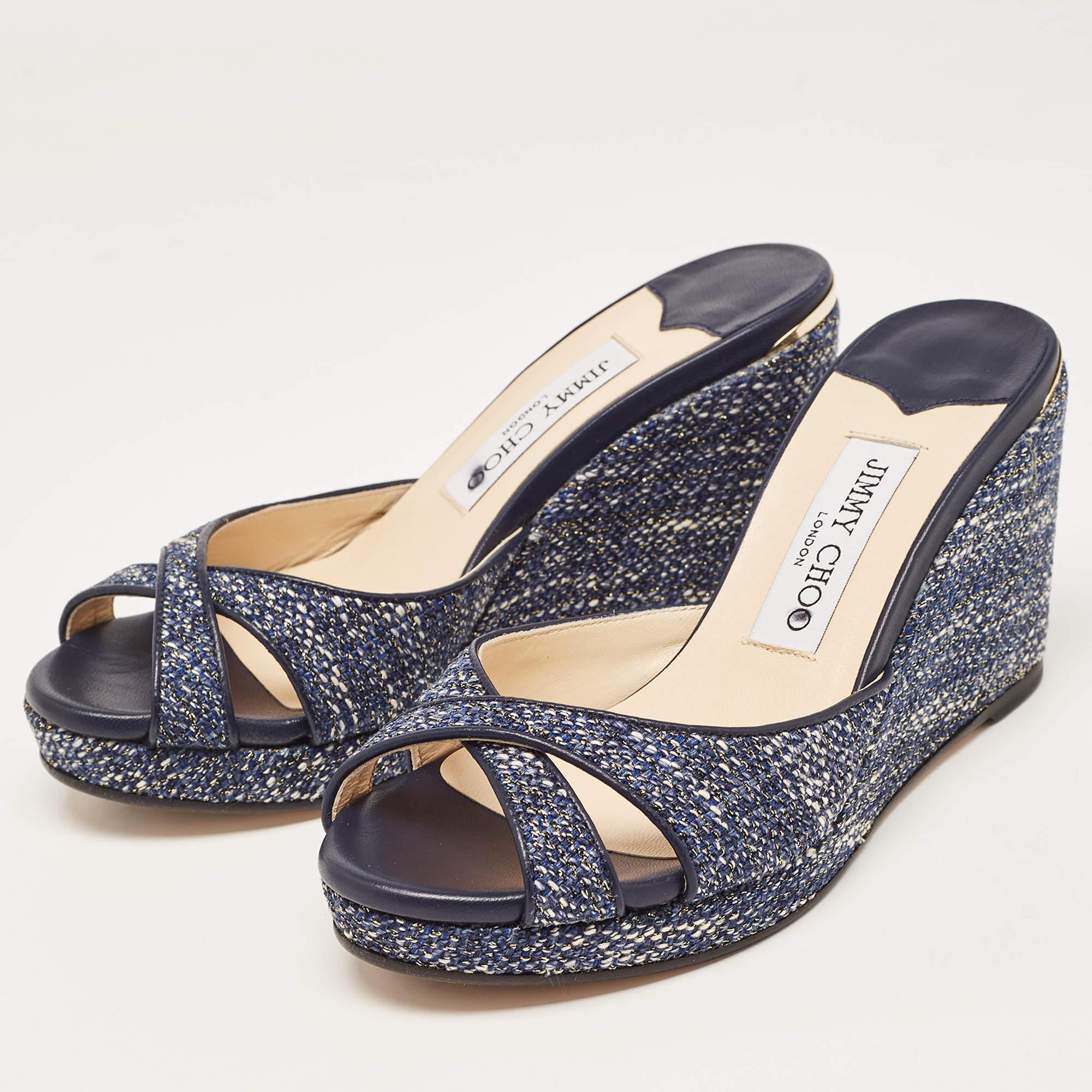 The Jimmy Choo sandals feature a sophisticated blend of navy blue tweed and leather. With a stylish wedge heel, they offer both elegance and comfort for any occasion.

Includes: Original Dustbag, Original Box