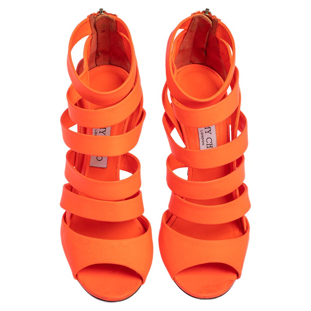 These statement sandals come from the house of Jimmy Choo. Crafted in Italy, they are made from neon orange leather in a caged design. They are complete with open toes, zip fastenings, and 11 cm high heels. They make for a great buy


