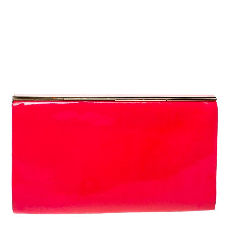 This gorgeous Cayla clutch by Jimmy Choo is a perfect example of the label's commitment to being chic, contemporary, and elegant at the same time. Designed to dazzle, this patent leather clutch has a magnetic snap-flap closure that opens to a