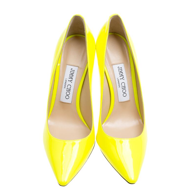Jimmy Choo brings to you these glamorous Romy pumps to make you look every inch of a diva. These neon yellow pumps are crafted from patent leather and feature an elegant silhouette. They flaunt pointed toes, 10 cm stiletto heels and leather lined