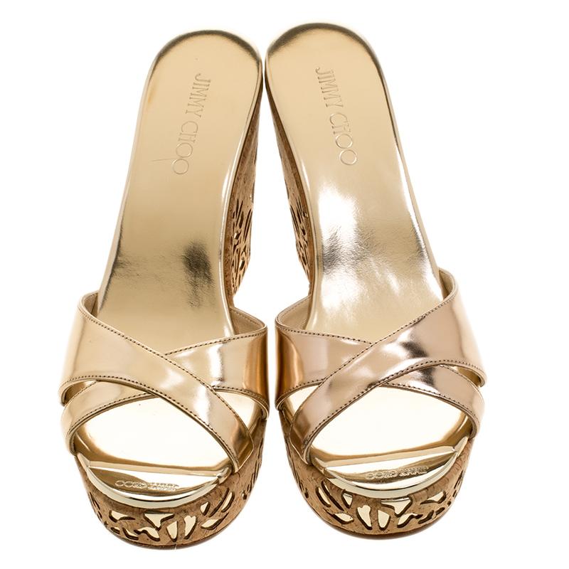 Coming from the house of Jimmy Choo, these nude sandals are set on a cork wedge sole with delicate cut-out detailing. The nude pair comes with two leather frontal cross-strap and can easily be styled with all outfits with great ease.

Includes: