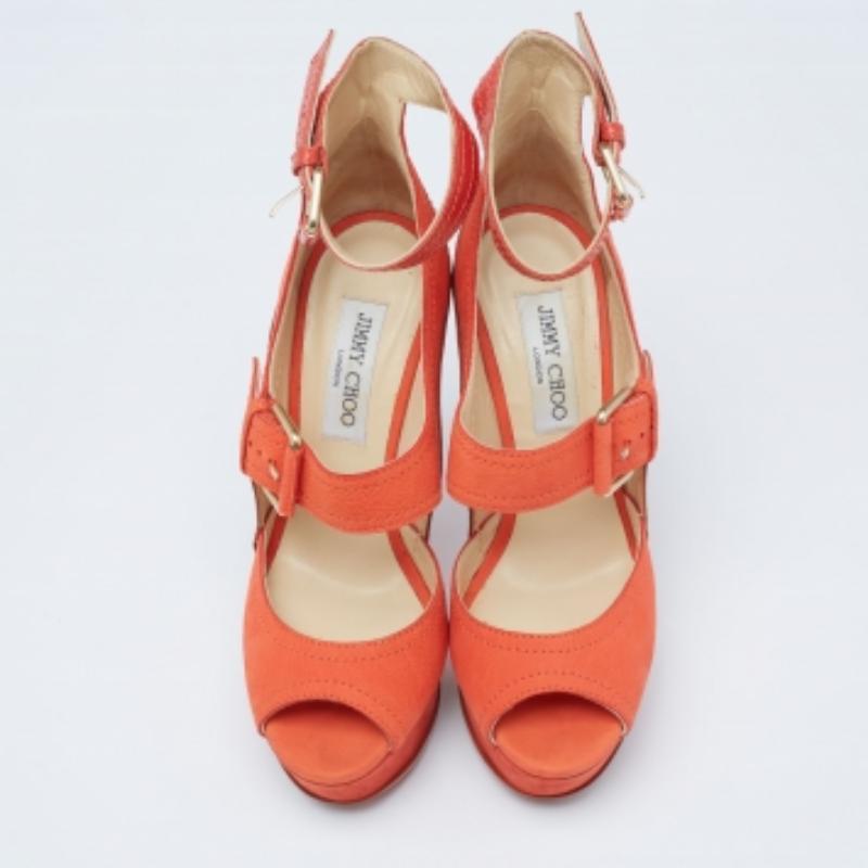 These Jimmy Choo sandals are made of leather and nubuck straps, added with gold-tone hardware, and lifted on platforms and slim heels. The orange sandals are secured with buckle closures.