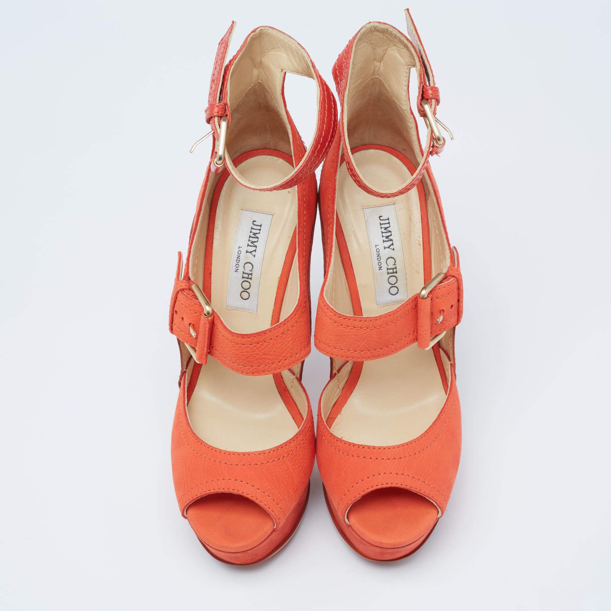 These Jimmy Choo sandals are made of leather and nubuck straps, added with gold-tone hardware, and lifted on platforms and slim heels. The orange sandals are secured with buckle closures.

