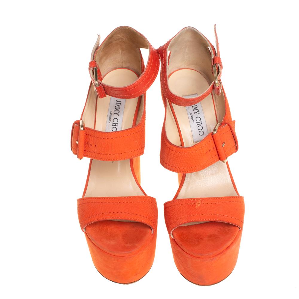 Make a bold style statement as you flaunt these Jimmy Choo sandals. They come crafted from orange nubuck and feature an open-toe silhouette. They have been styled with a single frontal strap, a mid strap, and an ankle strap with buckle fastening.