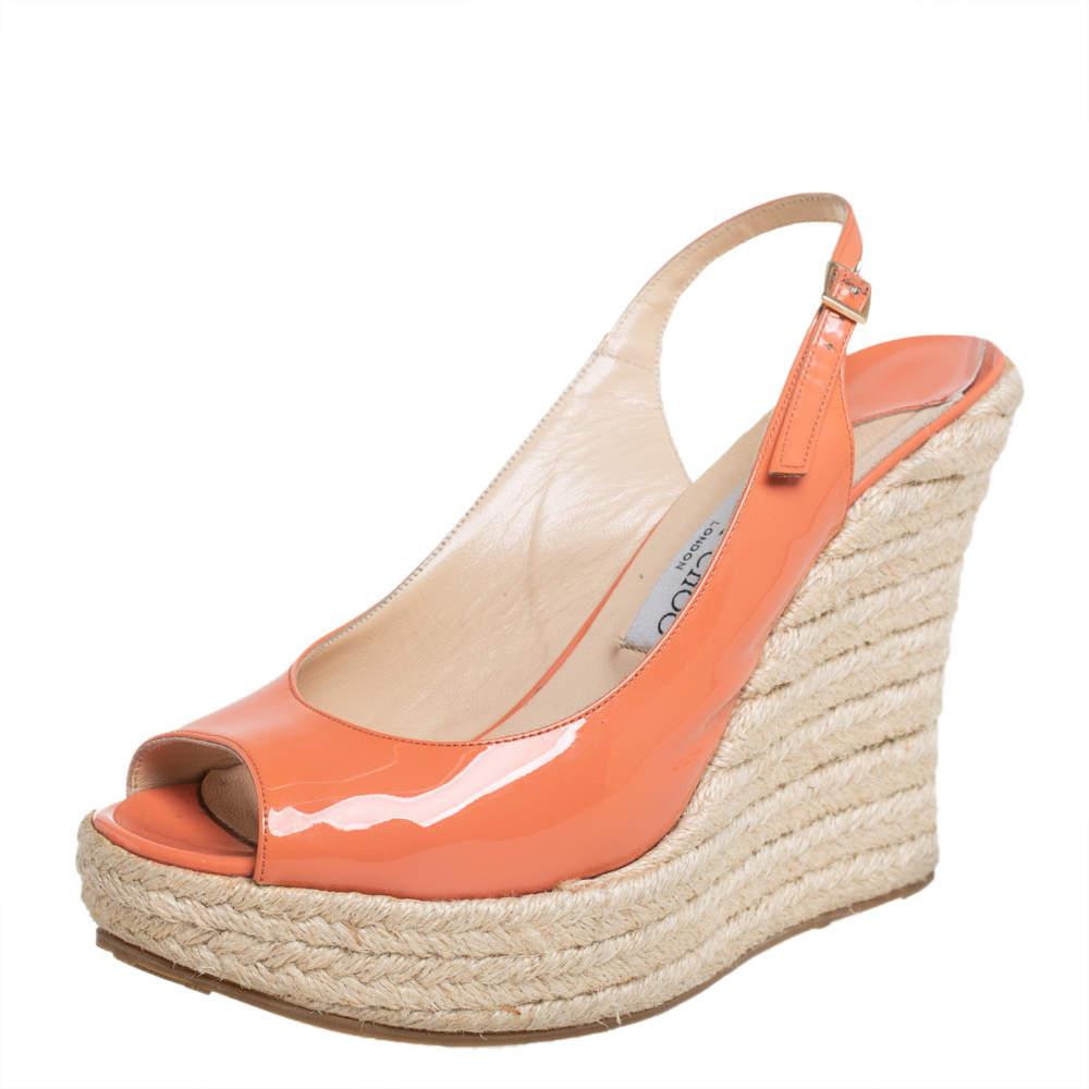 Look elegant and stylish in this beautiful pair of Jimmy Choo wedge sandals that are perfect to wear throughout the day and even for your casual evenings out. Constructed in orange patent leather, these sandals feature slingbacks and espadrille