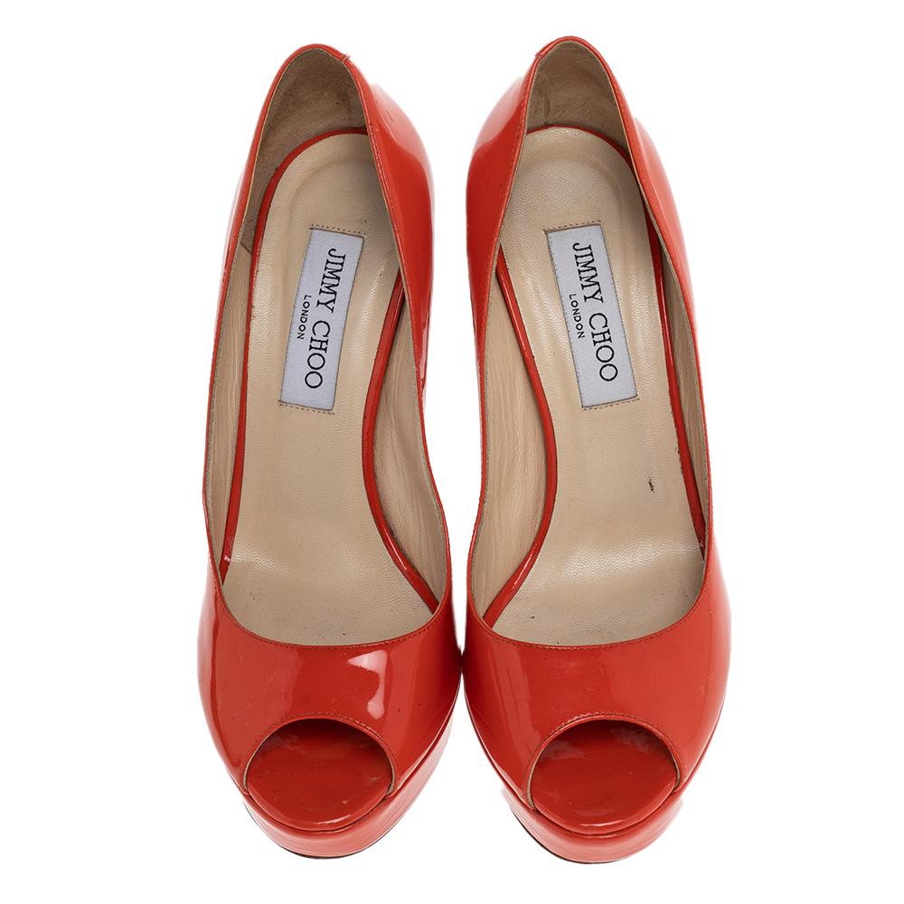 Step out like a diva as you wear these gorgeous pumps made by the House of Jimmy Choo. Featuring orange patent leather on the upper with 13 cm pointy heels, these peep-toe pumps are visually appealing and will definitely revamp your footwear