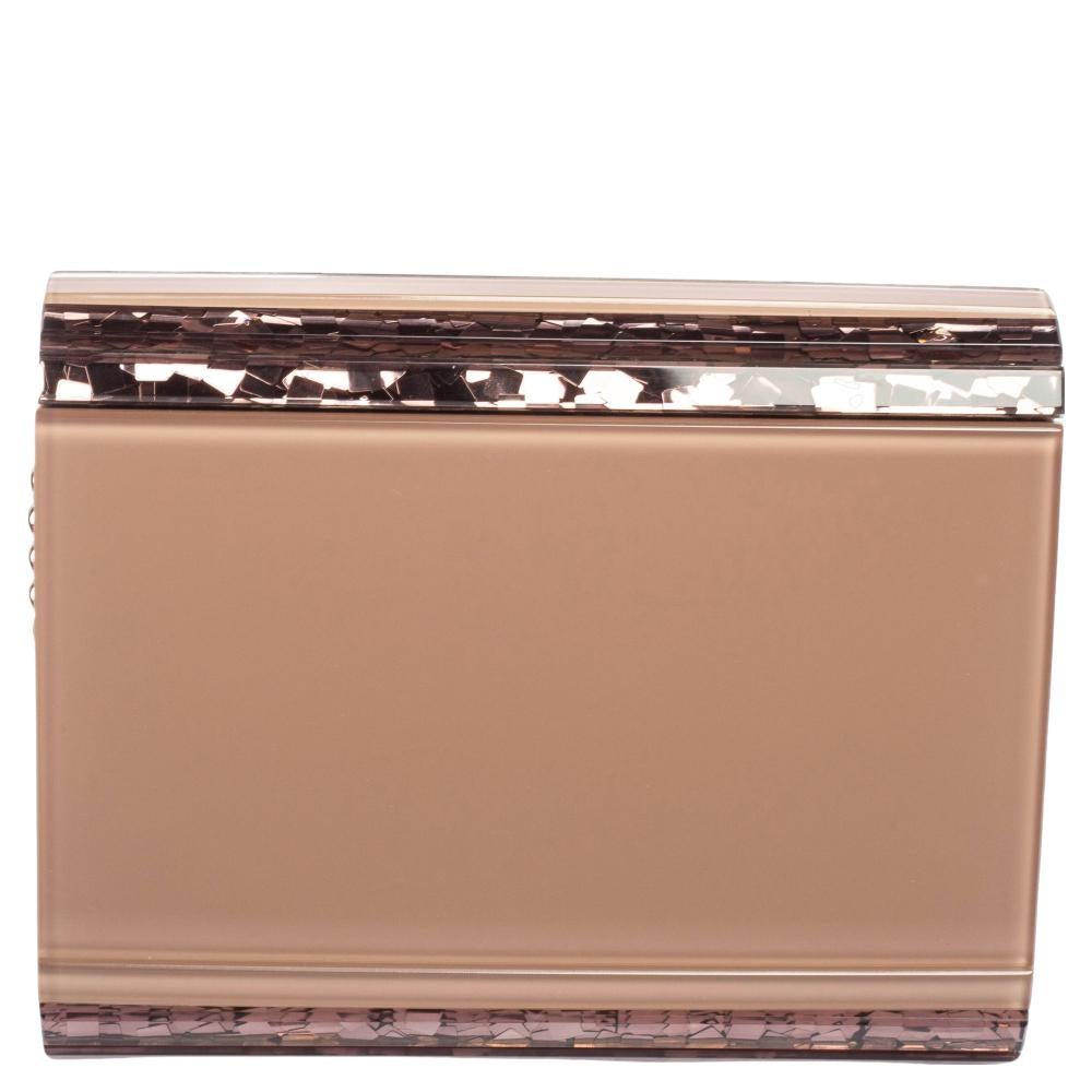 Classy and super stylish, this clutch bag is a Jimmy Choo creation. It is wonderfully crafted from pink acrylic as well as suede and shaped to complement all your elegant outfits. The insides are lined and sized to carry your necessities. The clutch