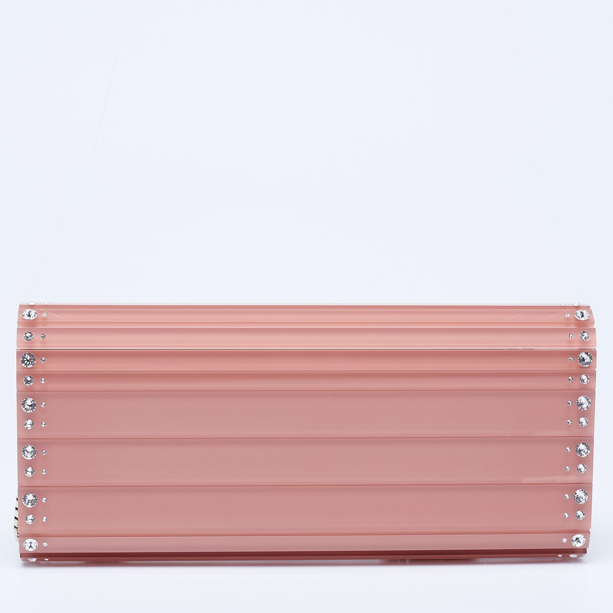 Redefine your party attire by carrying elegant pieces like this pretty clutch. The Sweetie clutch from Jimmy Choo brings luxe vibes and sophistication to any attire. It is made from pink acrylic into a structured silhouette. It has a sleek shoulder