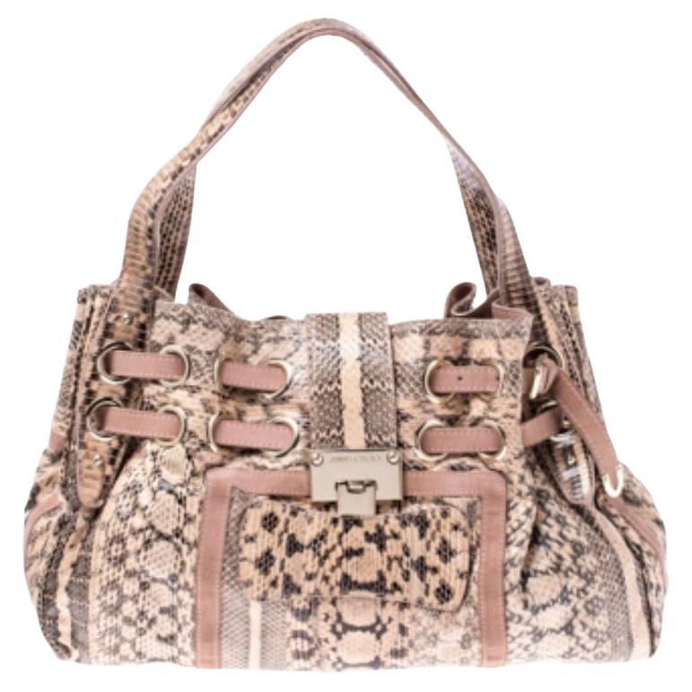 Own this gorgeous Jimmy Choo Riki bag today and light up your closet! Crafted from python and suede, this stunning number has a flap top with a signature lock and a spacious Alcantara interior. It also features two top handles, gold-tone hardware,