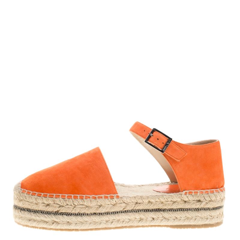 Step out in full style this summer with these pretty espadrilles from Jimmy Choo. Featuring a suede exterior in pop orange, this trendy round-toe pair is completed with chains within the braided platforms, ankle straps, and comfortable insoles. Soak