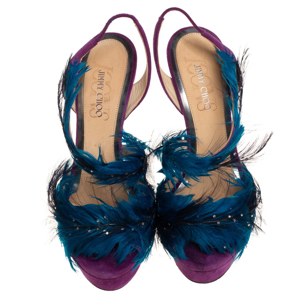 These Marlene sandals from Jimmy Choo are simply delightful! The purple and blue sandals are crafted from suede and feature an open-toe silhouette. They have been adorned with eye-catching feathers that crown the vamps. They come equipped with