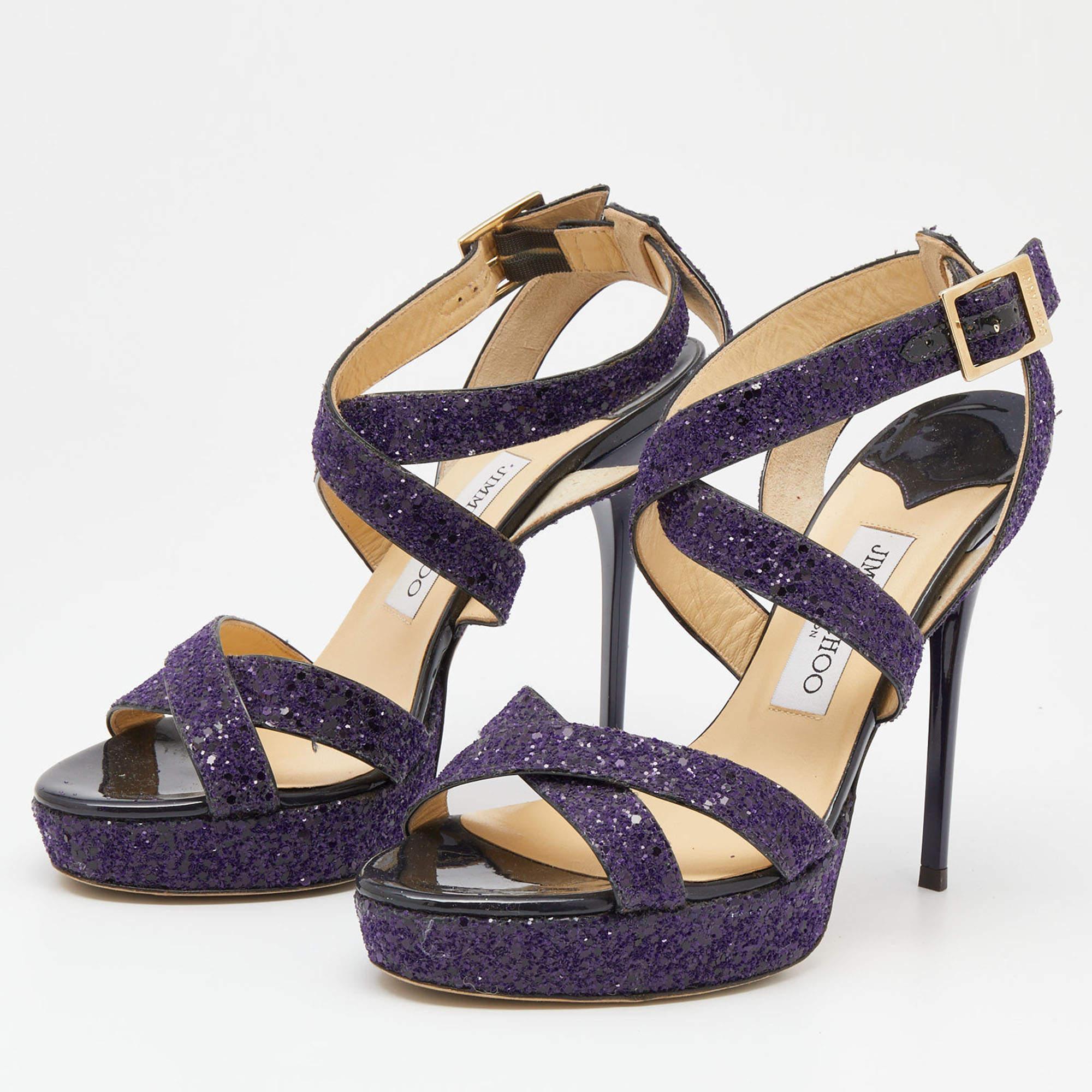 Feel great every time you step out in these platform sandals from Jimmy Choo! Beautifully crafted from glitter into a criss-cross strappy design, they successfully present a lovely appeal. The purple pair carries open toes, stiletto heels, and