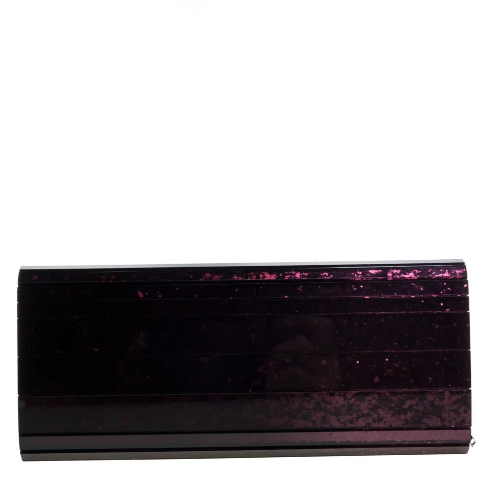 Classy and super stylish, this clutch is a Jimmy Choo creation. It has been wonderfully crafted from glitter acrylic in an ombre purple shade, and shaped to complement all your elegant party outfits. The insides are sized to carry your necessities