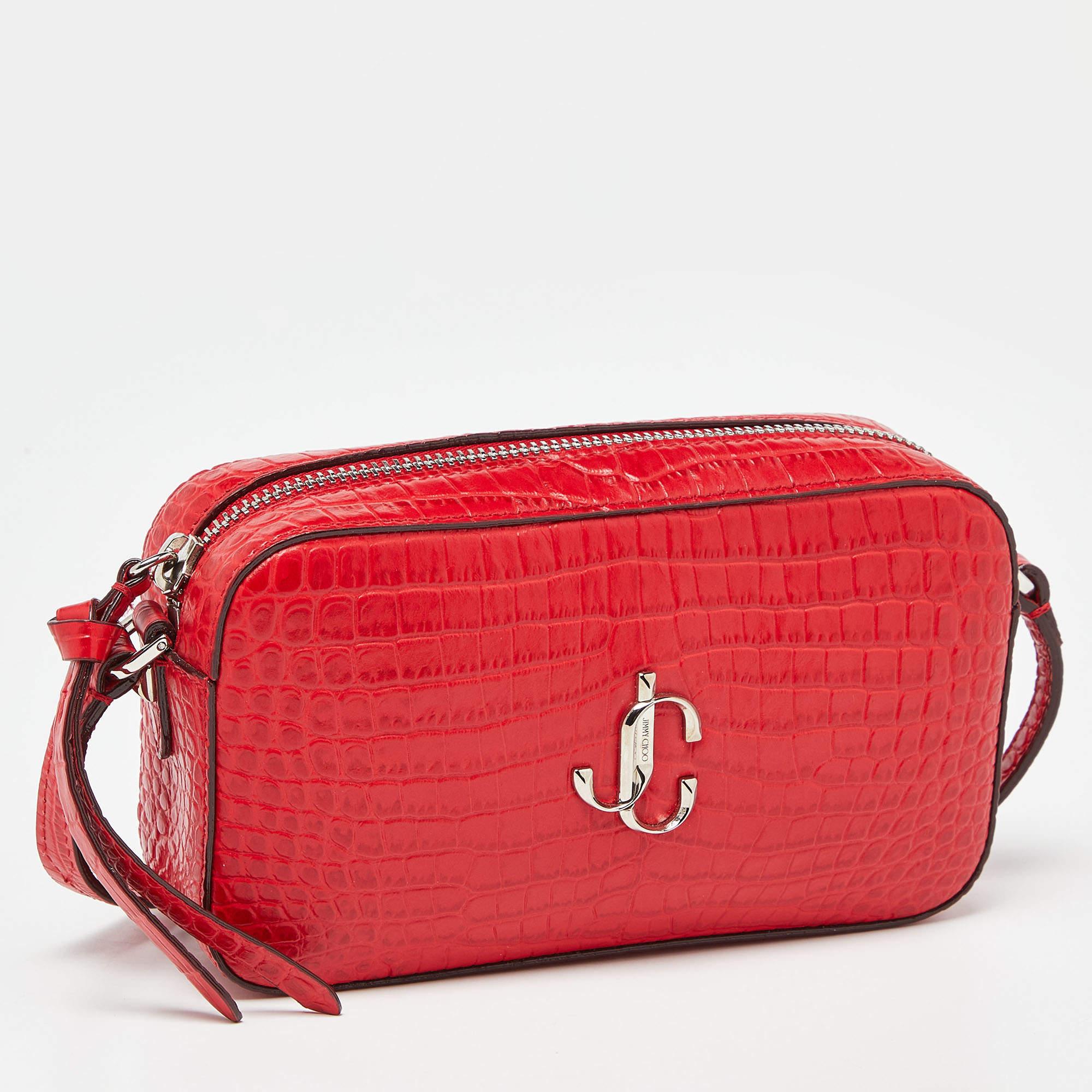 This camera bag by Jimmy Choo is a creation that is not only stylish but also exceptionally well-made. Meticulously crafted, it flaunts a modern JC logo and a top zipper leading way to a well-lined interior.

