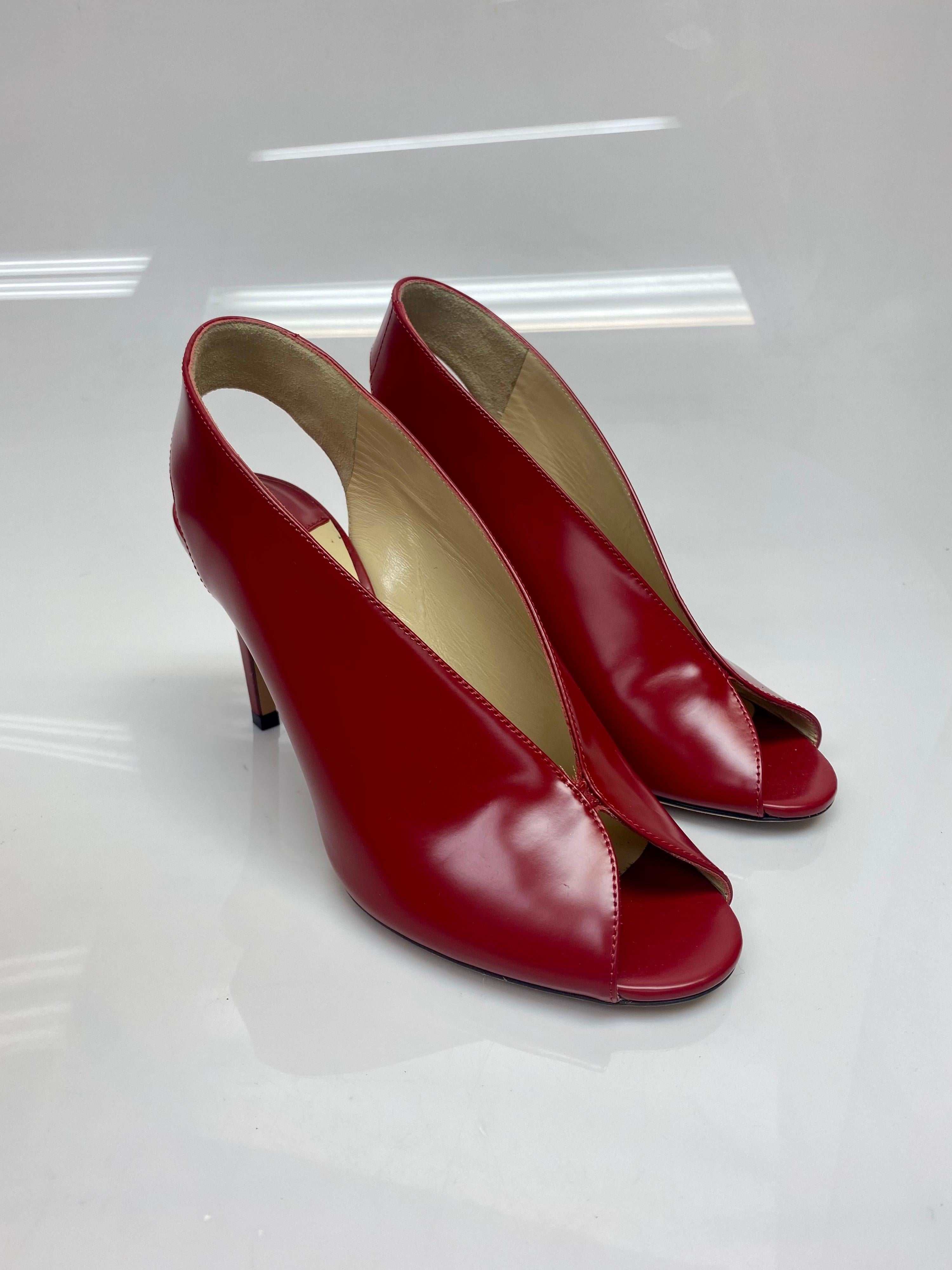 Jimmy Choo Red Leather Singback Heels - Size 37. Be a trendsetter by waltzing out in this exquisite Jimmy Choo pair. Crafted from patent leather, these red beauties feature peep toes and singback's for comfort. Slip them on over simple outfits and