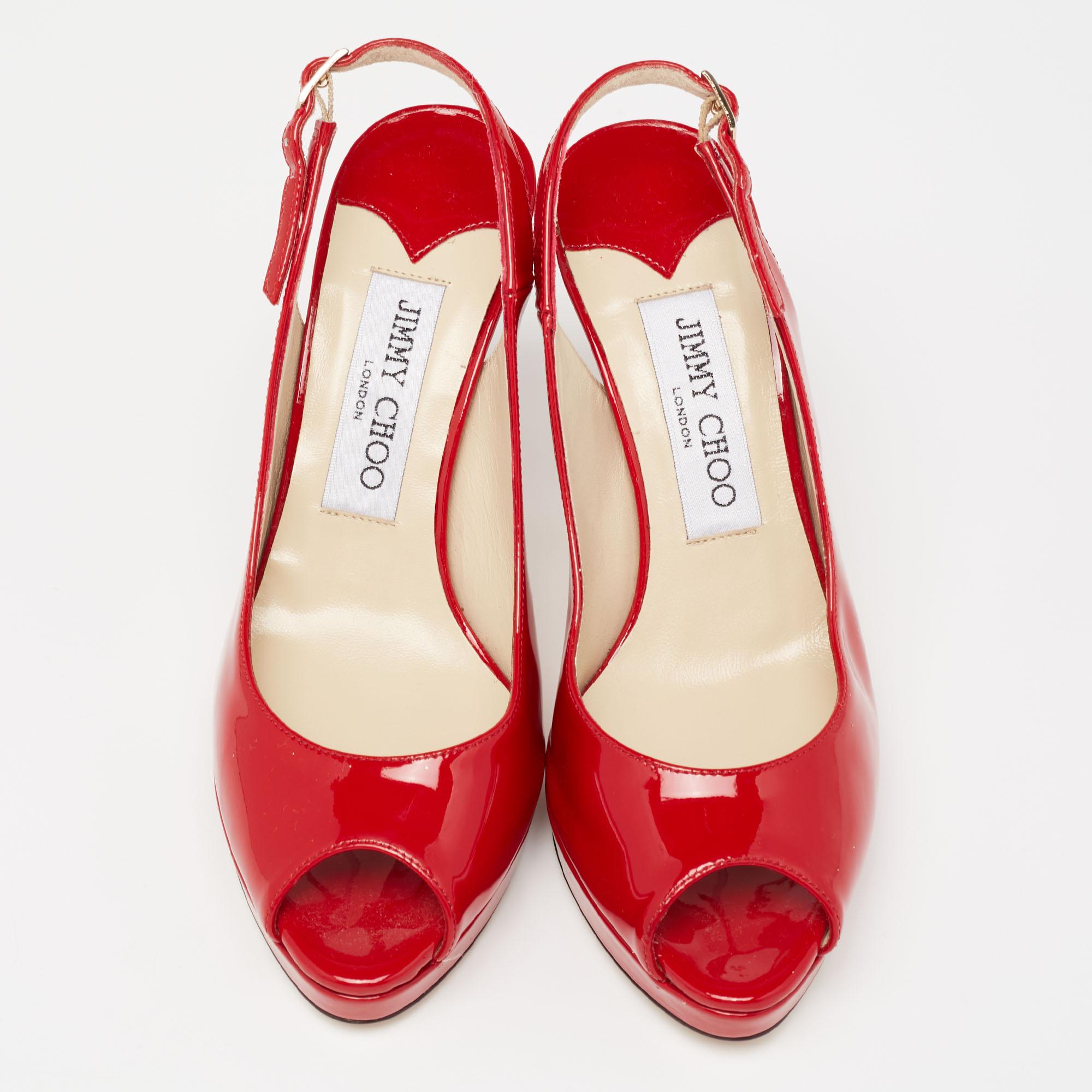 This timeless pair of sandals from Jimmy Choo looks even better on the feet. The shoes have an elegant design made from red patent leather, with low platforms, high heels, and buckle slingbacks for a sleek finish.

Includes: Original Dustbag