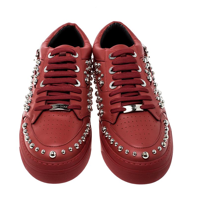 A pair of shoes to match your suave persona is here in the form of these red sneakers from Jimmy Choo. They've been crafted from leather and styled with laces, buckles and silver-tone studs. Leather insoles and the brand label on the heels