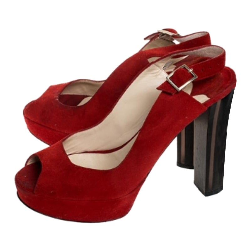 These stunning red sandals by Jimmy Choo have been crafted from suede. They feature peep toes, slingbacks, platforms and 12.5 cm block heels. They are finished with silver-tone buckles, leather lining, insoles and soles. They are designed to deliver