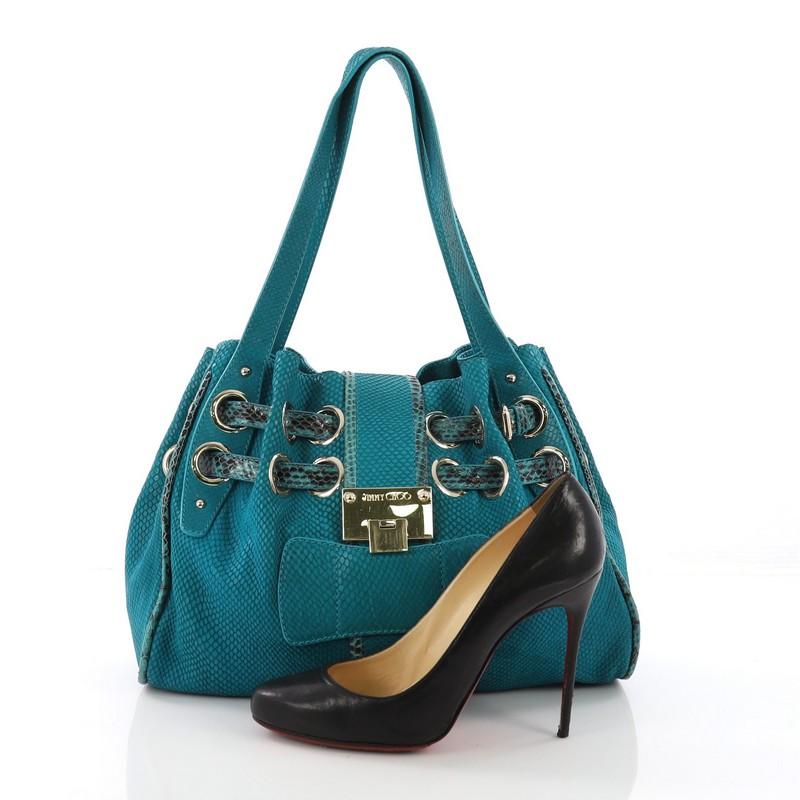 This Jimmy Choo Riki Hobo Embossed Suede with Snakeskin, crafted in turquoise embossed suede with genuine snakeskin, features tall dual flat handles, pleated dual drawstring at top, and gold-tone hardware. Its flip-lock closure opens to a brown