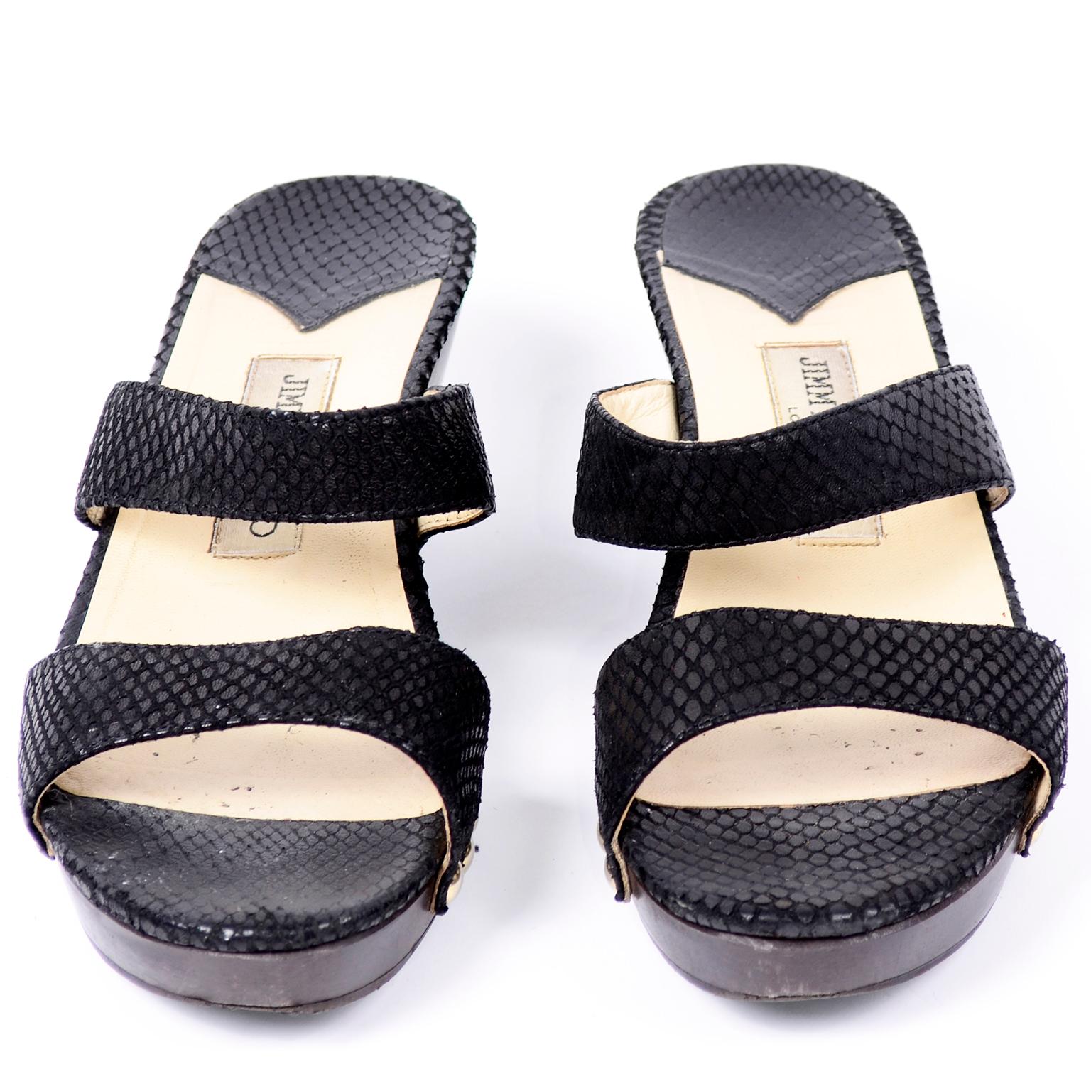 There are great, easy to wear Jimmy Choo London black snakeskin sandals with a chunky heel. These fab slide shoes have to cross straps and the Jimmy Choo metal plaque on the heel. Made in Italy. Size 38. 
BALL: 3 3/8