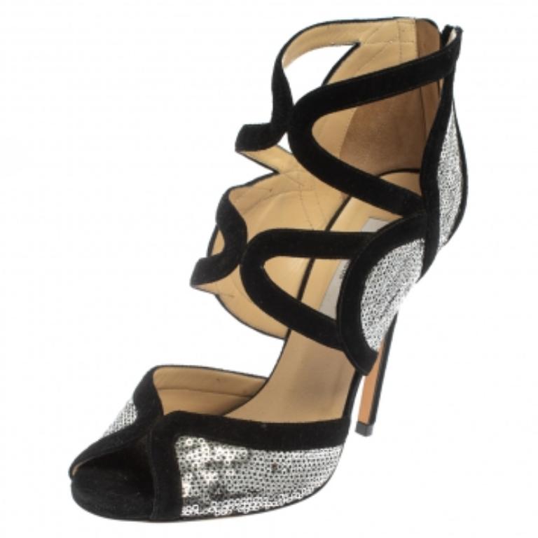 The Tempest sandals reinforce Jimmy Choo’s brilliant craftsmanship in shoemaking. This pair of high-heeled sandals are swathed in silver sequins, making it a hit among fashion mavens. The black suede trimming and the cut-out details together, make