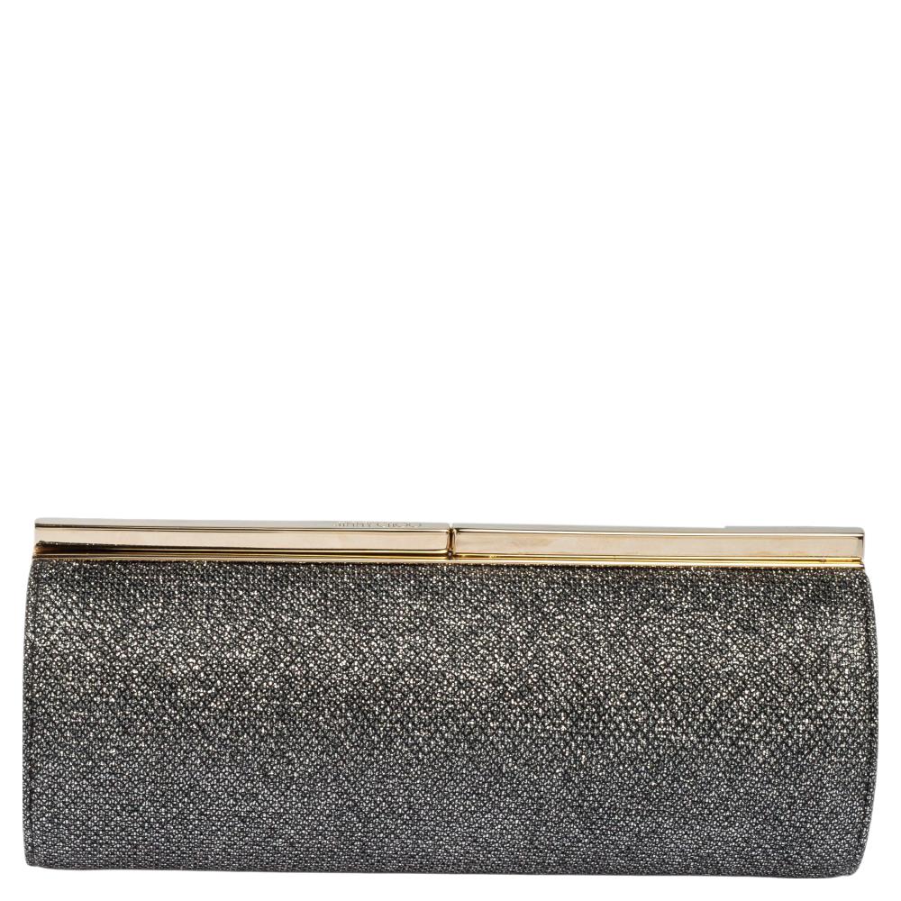 Beautifully crafted, this clutch bag by Jimmy Choo is a must-have for your party and evening style edit. Covered in coarse glitter, it is detailed with a simple lock on the gold-tone frame top. It opens to a satin-lined interior.

Includes: Original