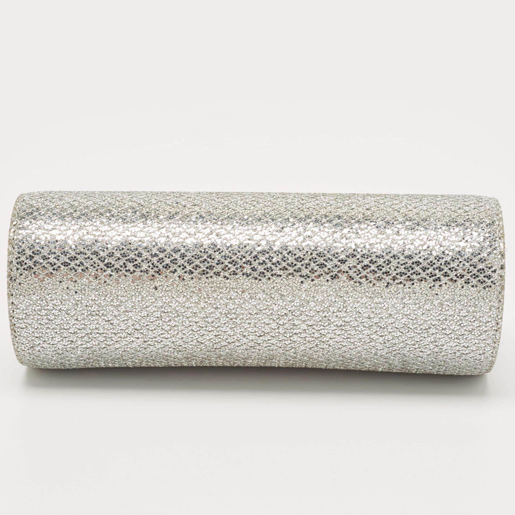 This Jimmy Choo silver clutch is a creation marked by excellent craftsmanship and refined style. This barrel-shaped clutch is crafted with skill and impeccably finished to be a luxurious accessory in your hand.

Includes: Original Dustbag

