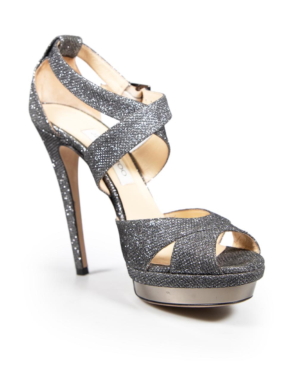 CONDITION is Very good. Minimal wear to the sandals is evident. Pluck to the weave on both heels and both ankle straps. Scratching to both platforms on this used Jimmy Choo designer resale item. This pair of shoes comes in the original dust bag and