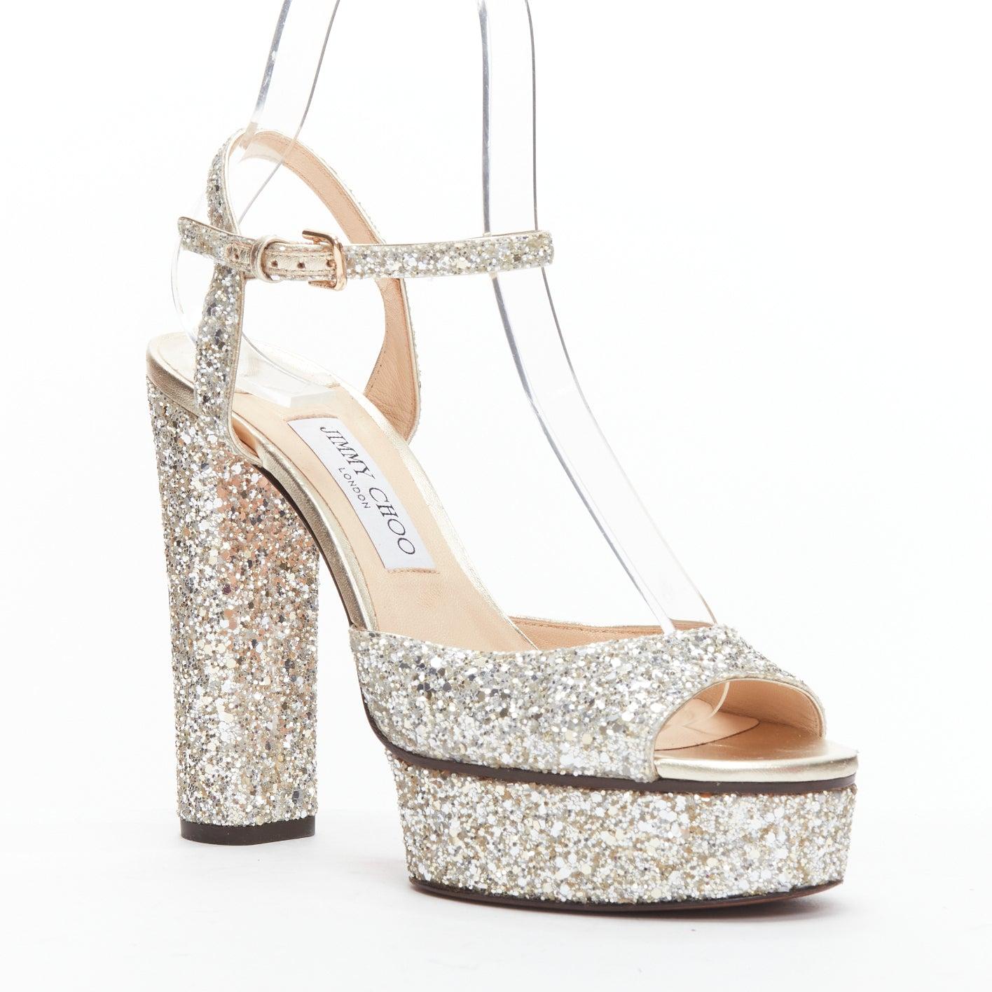JIMMY CHOO silver glitter open toe ankle strap platform heels EU39
Reference: BSHW/A00171
Brand: Jimmy Choo
Material: Leather
Color: Silver
Pattern: Solid
Closure: Ankle Strap
Lining: Nude Leather
Extra Details: Chunky heels.
Made in: