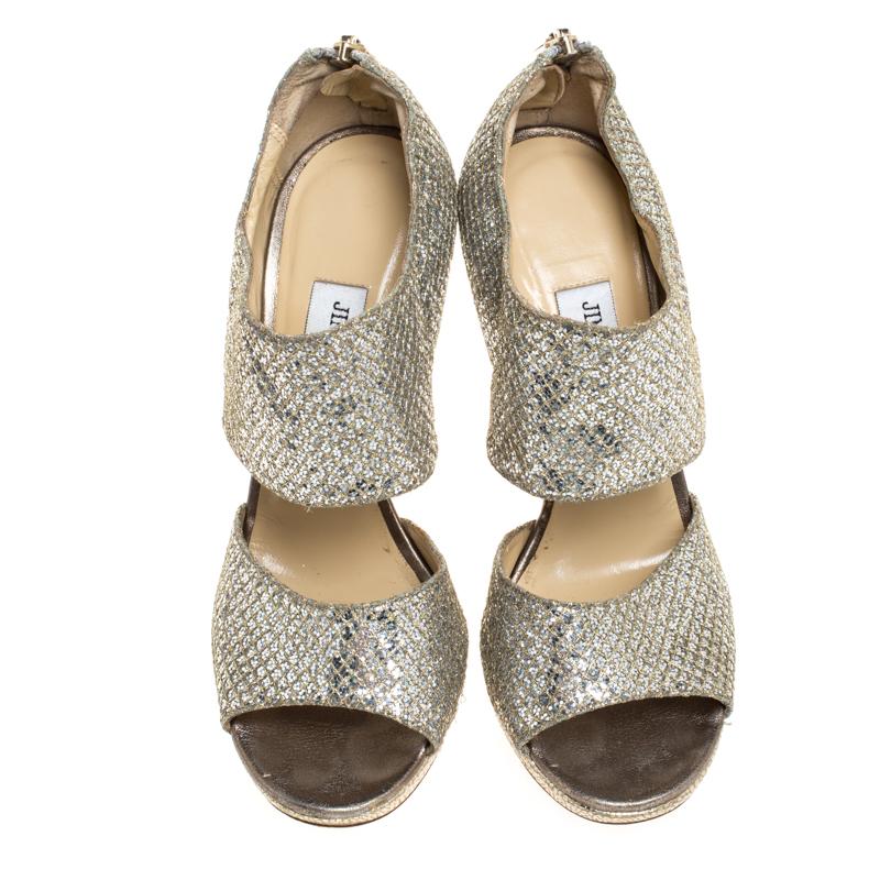 This stylish, chic and modish pair of Private platform sandals for parties by Jimmy Choo is all you'll need. It is crafted from beautiful glitter fabric and comes with two broad straps. The insoles are leather-lined and carry brand labeling along