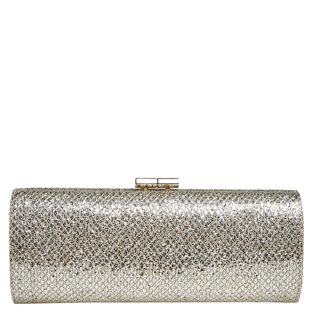 This Jimmy Choo clutch has a shimmery exterior in glitter fabric enhanced with gold-tone hardware. The satin-lined interior is sized to hold all your party essentials. This easy-to-carry clutch will garner you many compliments.

Includes: Original