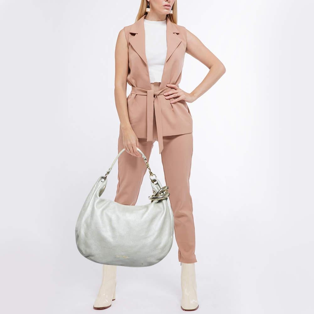This stunning hobo from Jimmy Choo is crafted in Italy and is sure to make a standout addition to your collection. The Solar hobo is crafted from silver leather and comes with a single top handle carrying twin metal bangle detail. The bag is