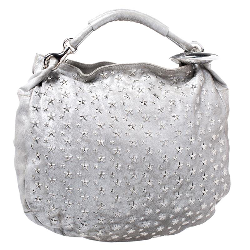 This stunning hobo from Jimmy Choo is handcrafted in Italy and is sure to make a standout addition to your collection. The star-studded Sky bangle hobo is crafted from silver leather and comes with silver-tone hardware and a flat top handle. The bag