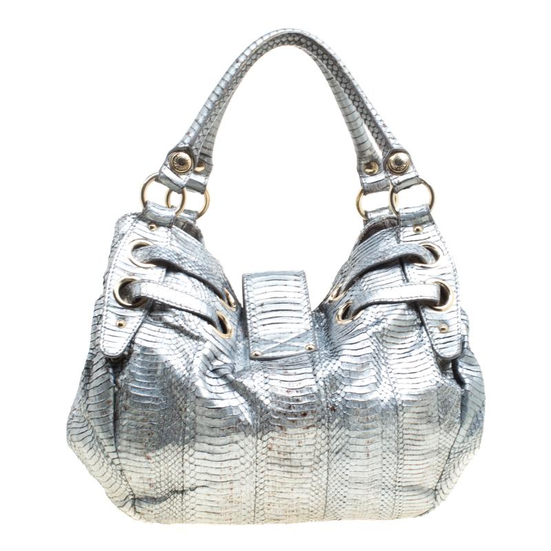 Complement the fashionista in you by adding this Riki tote from Jimmy Choo to your closet. Trendy and gorgeous to look at, this silver bag made from python-embossed leather is a must-have. The bag is held by two handles and an Alcantara interior is