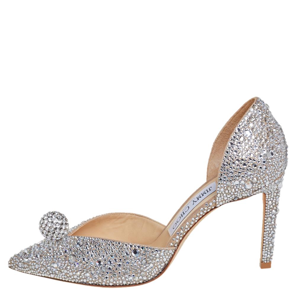 Jimmy Choo’s glamorous spirit enlivens in these stunning pumps that will add oodles of style to your ensemble. Crafted from silver suede, these D'Orsay pumps are embellished with crystals all over and balls on uppers for an opulent touch. These