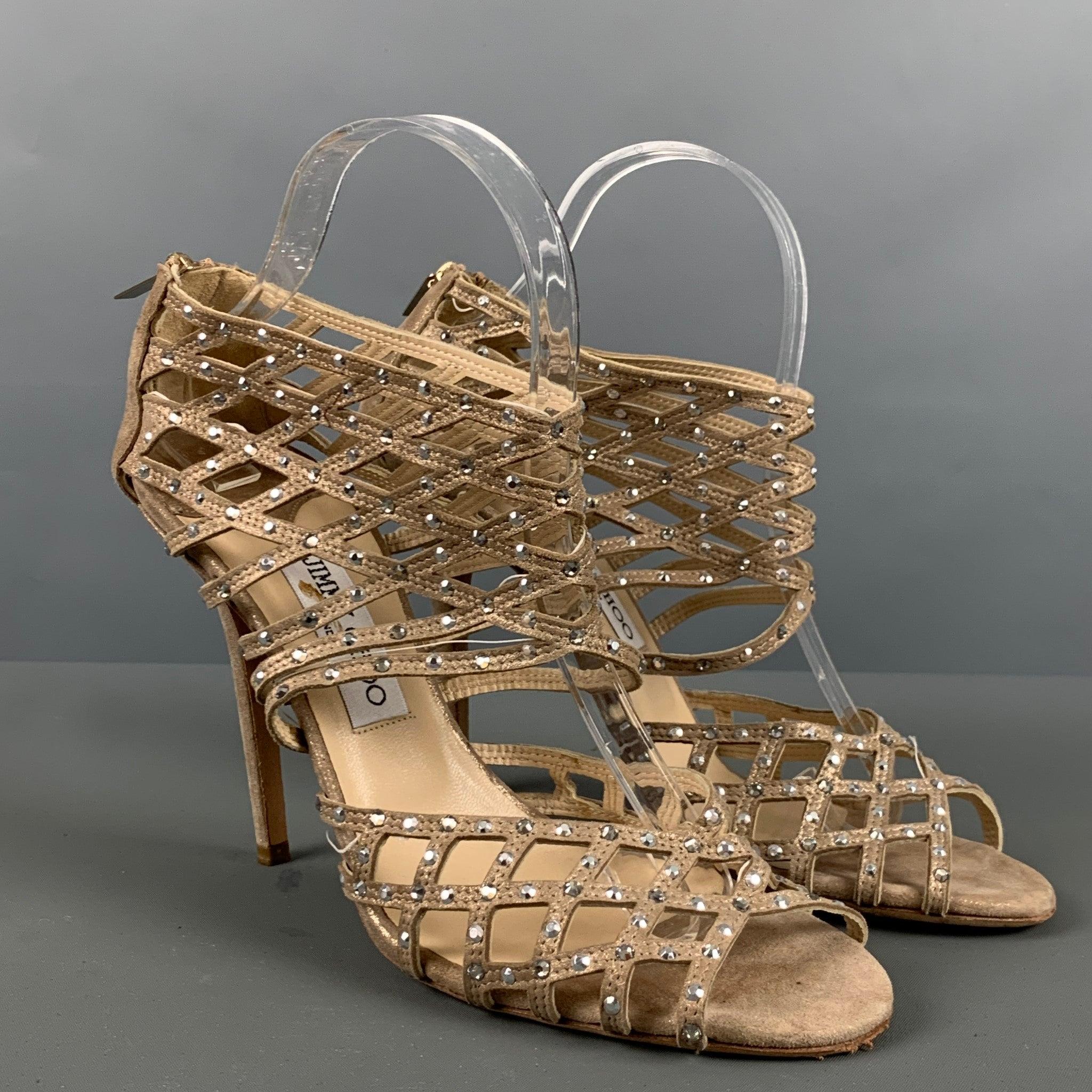 JIMMY CHOO sandals comes in a beige gold tone suede featuring a rhinestones details, caged design, and an ankle strap. Made in Italy.Good Pre-Owned Condition. Moderate signs of wear. 

Marked:   40 

Measurements: 
  Heel: 4.75 inches 
  
  
