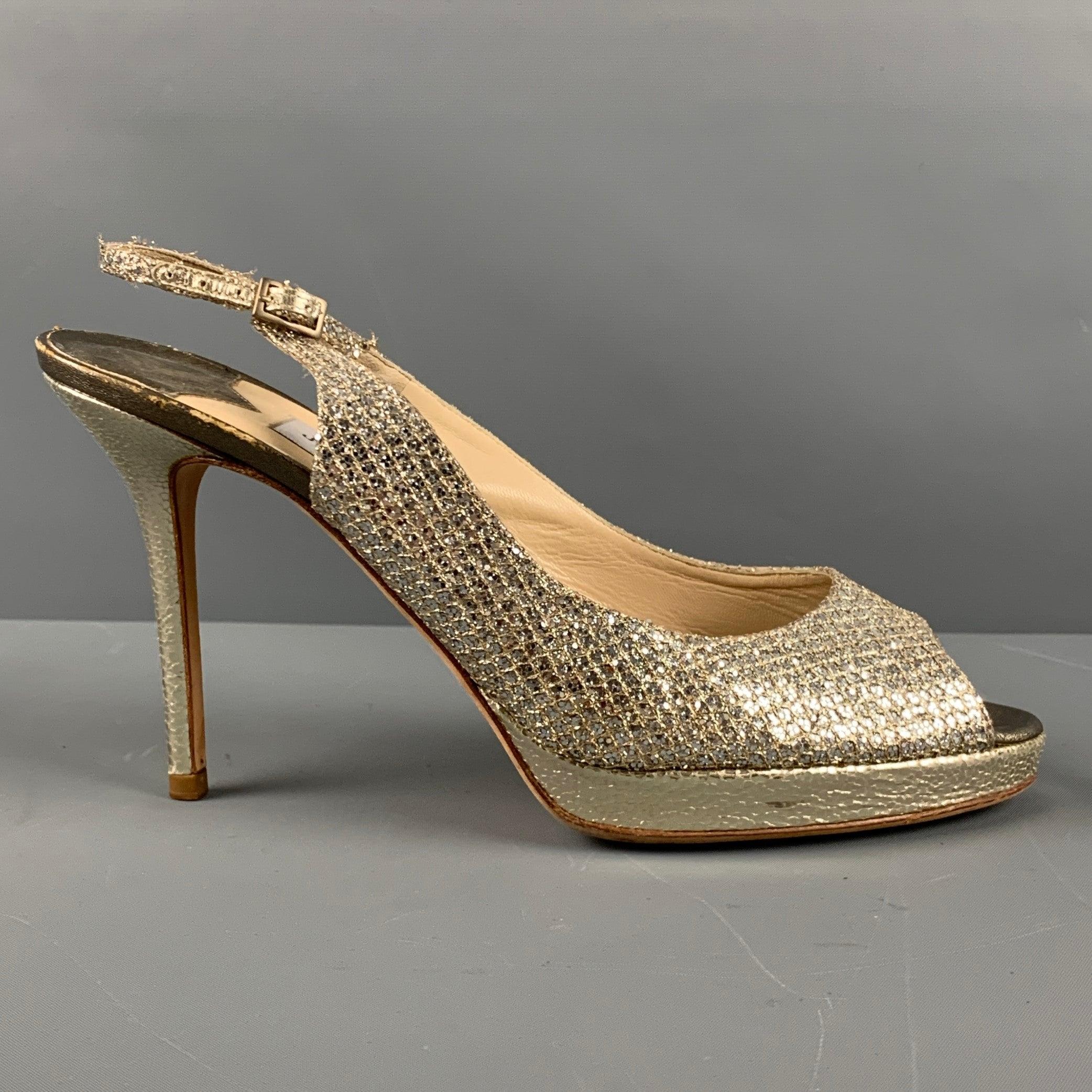 JIMMY CHOO sandals in a silver metallic leather featuring slingback style, sparkly fish scale design, and peep toe. Made in Italy.Very Good Pre-Owned Condition. Moderate signs of wear. 

Marked:   40Heel: 4.5 inches 
  
  
 
Sui Generis Reference: