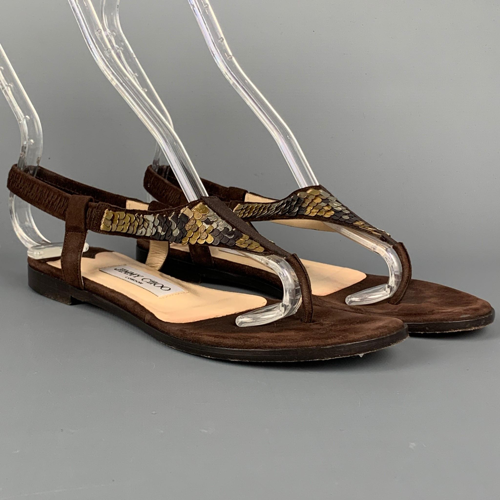 JIMMY CHOO sandals come in a brown & gold sequined suede featuring a flat style and a slingback strap. Made in Italy.

Very Good Pre-Owned Condition.
Marked: EU 36

Outsole: 3 in. x 9 in. 