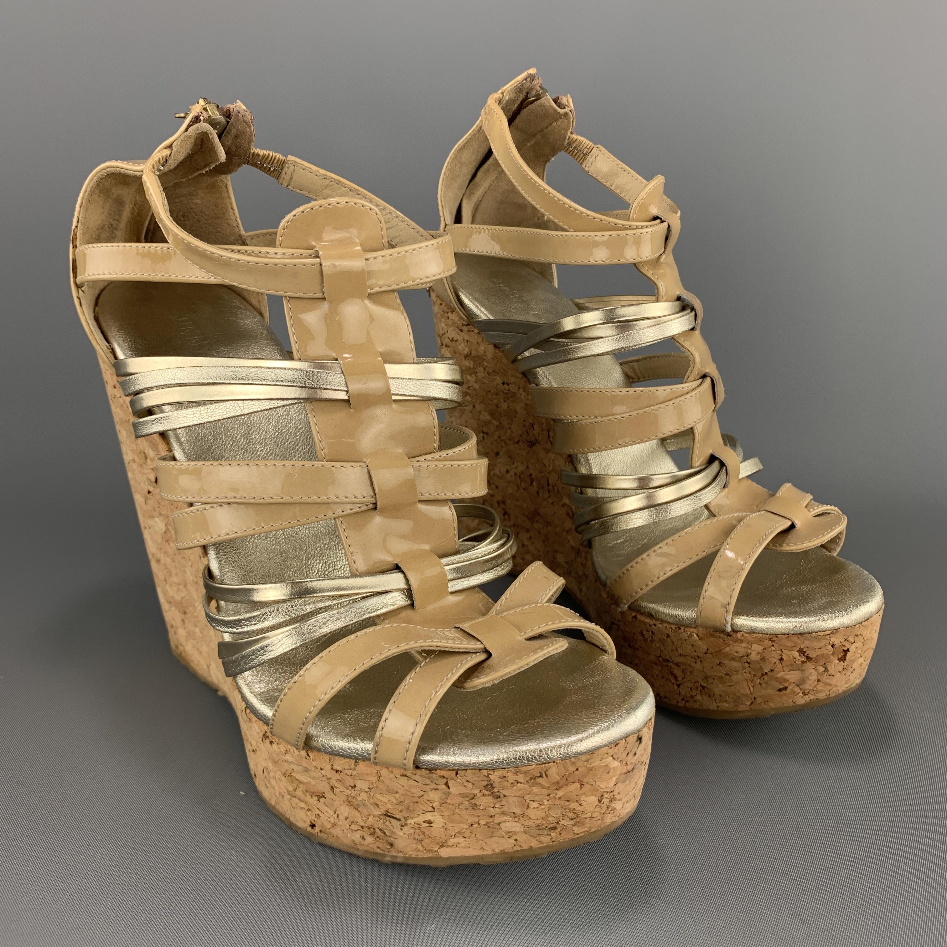 JIMMY CHOO sandals come in beige patent leather with silver straps and platform cork wedge heel. Made in Spain.

Very good Pre-Owned Condition.
Marked: IT 37

Measurements:

Heel: 5.75 in.
Platform: 1.5 in.