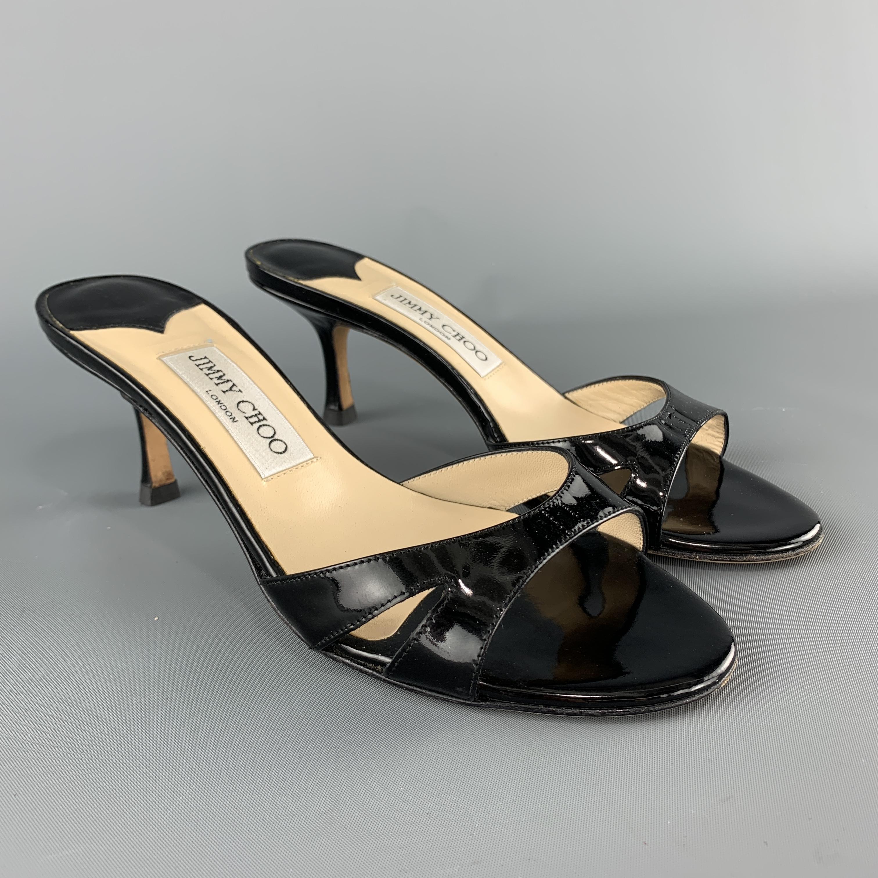 JIMMY CHOO mule sandals com ein black patent leather with cutout strap and lacquered heel. ade in Italy.

Excellent Pre-Owned Condition.
Marked: IT 37.5

Heel: 3 in.  
