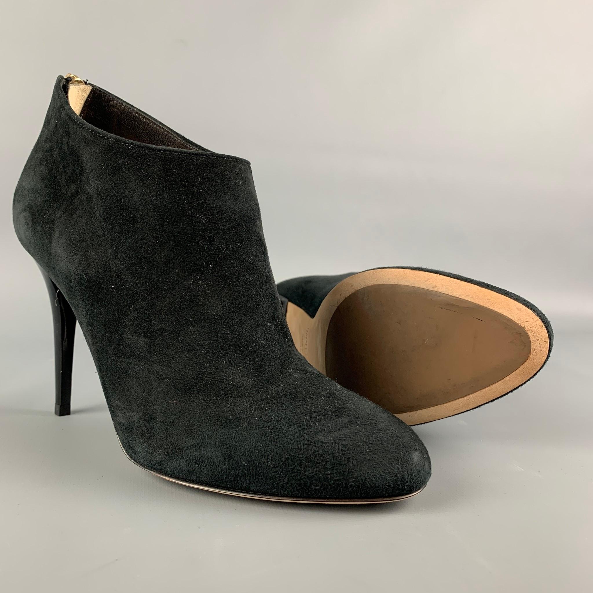 JIMMY CHOO ankle boots comes in a black suede featuring a back zipper closure, wooden sole, and a stiletto heel. Made in Italy.

Very Good Pre-Owned Condition.
Marked: 38

Measurements:

Heel: 4 in. 