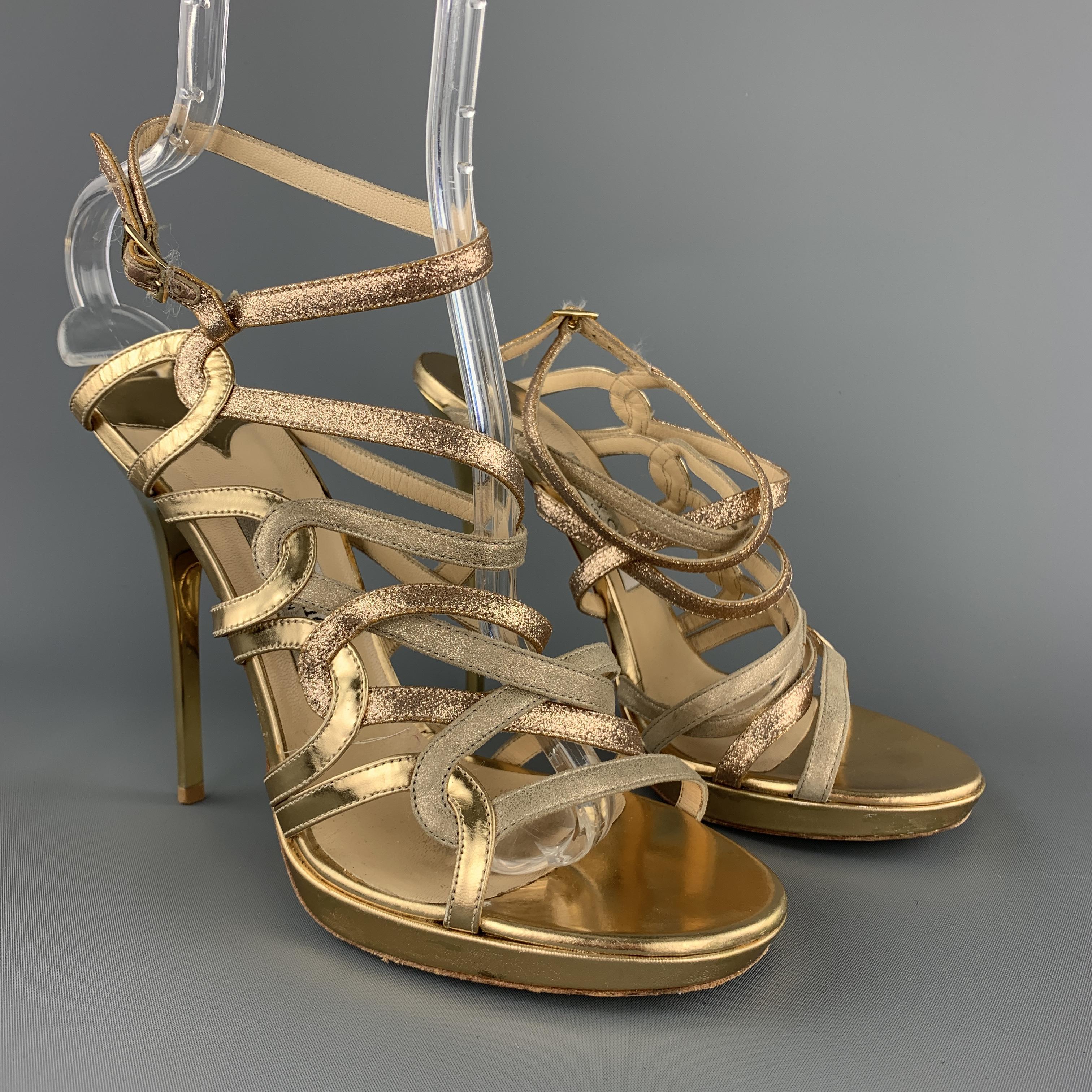 JIMMY CHOO sandals feature woven pink and gold sparkle and metallic leather straps, low platform, and gold tone metal stiletto heel. Wear throughout. Made in Italy.

Good Pre-Owned Condition.
Marked: IT 40

Measurements:

Heel: 5.45 in.
Platform: