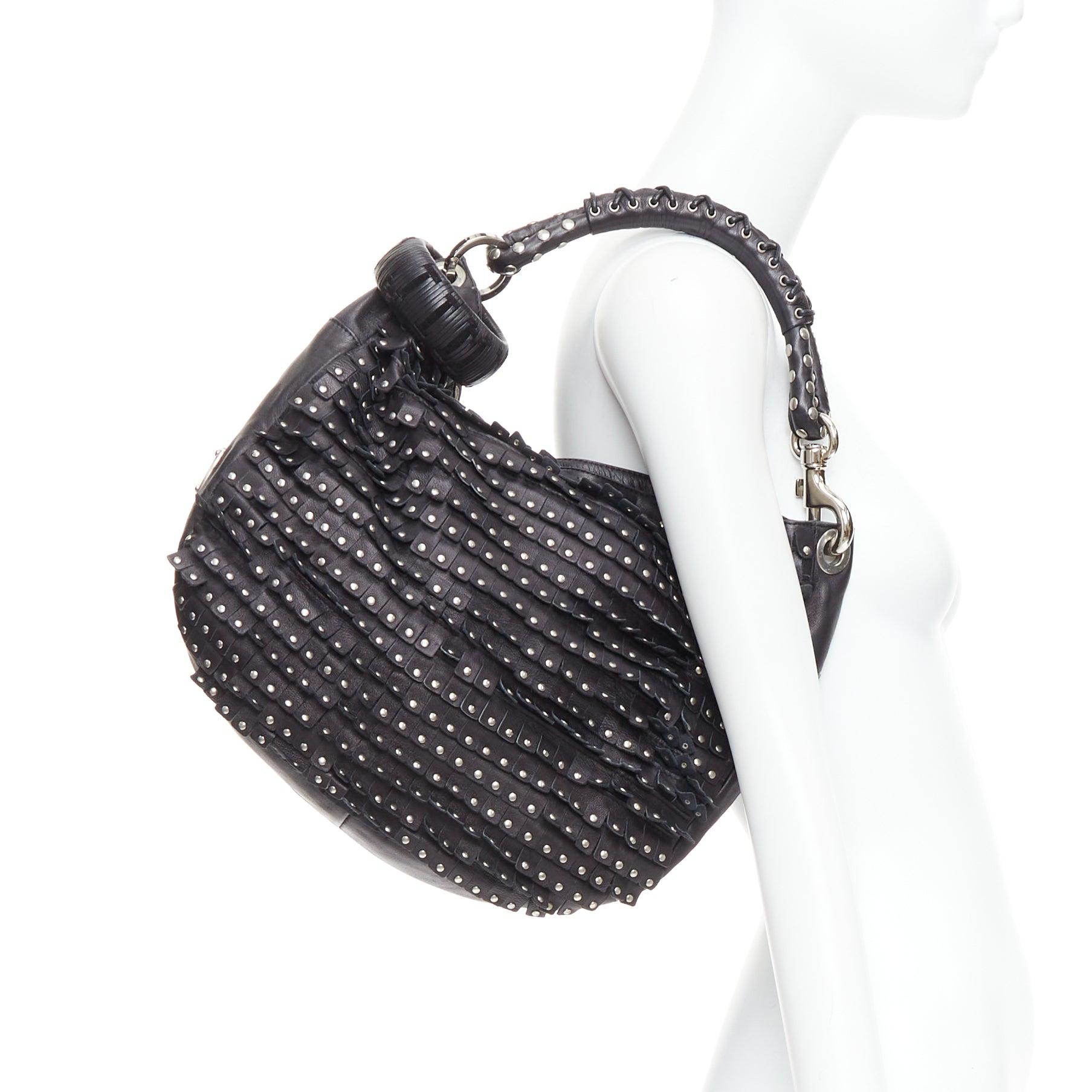 JIMMY CHOO Sky black studded suede fringe cuff strap hobo bag
Reference: JHDN/A00004
Brand: Jimmy Choo
Model: Sky
Material: Leather
Color: Black, Silver
Pattern: Studded
Closure: Zip
Lining: Beige Microsuede
Extra Details: Bangle detail at