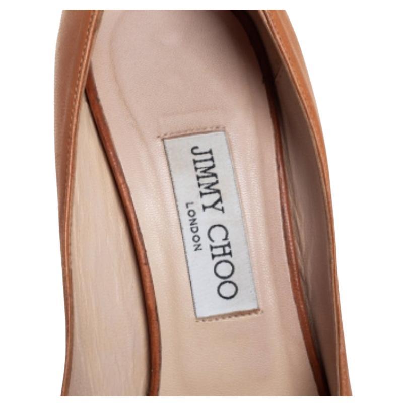 You can surely count on this chic and modish pair of pumps coming from Jimmy Choo to counter an impressive finish. Crafted from tan leather, they feature peep toes along with an elegant structure. The insoles are leather lined and carry brand