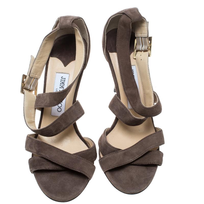 Feel great every time you step out in these sandals from Jimmy Choo! Beautifully crafted from suede in a strappy design, they successfully present a lovely appeal. The pair carries open toes, stiletto heels, and buckles at the ankles.

Includes: The